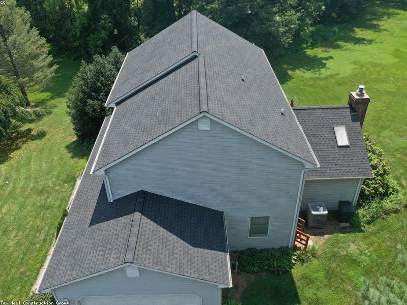 Aerial view of a residential asphalt shingle roof ready for replacement